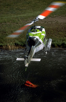 Bell 205 dipping Bambi Bucket in pond